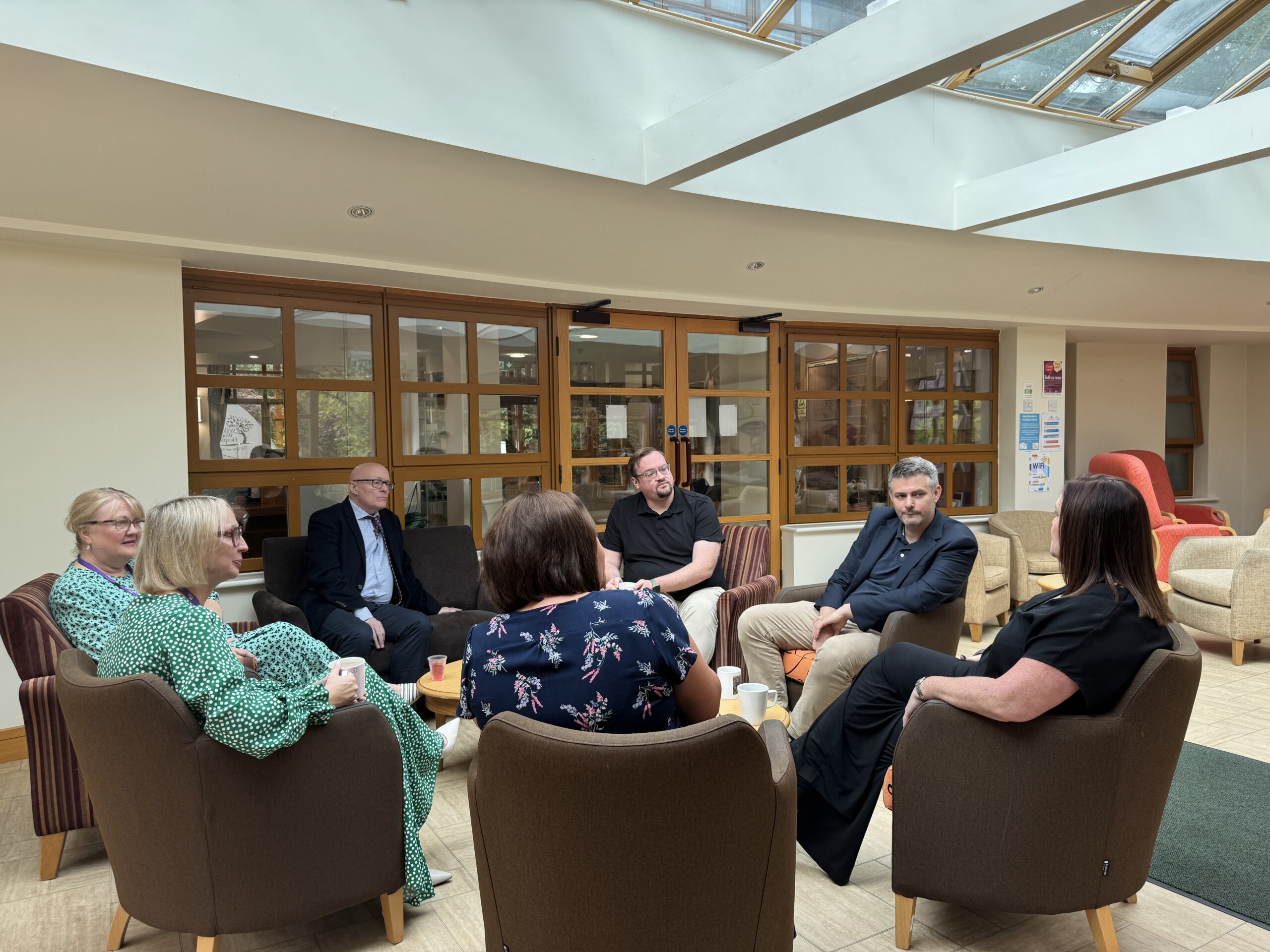Jon and Damien speaking with SMT and Chairman in Garden Room